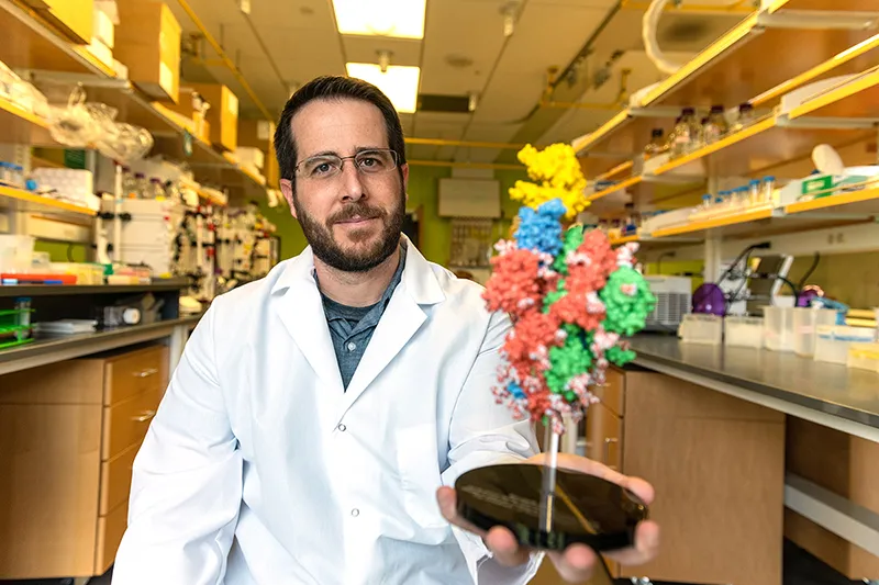 Professor poses in lab