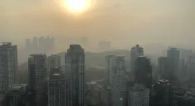 A city skyline covered with thick smog.