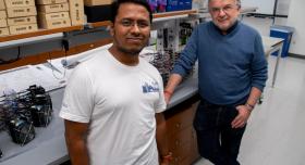 Two people stand in a laboratory.