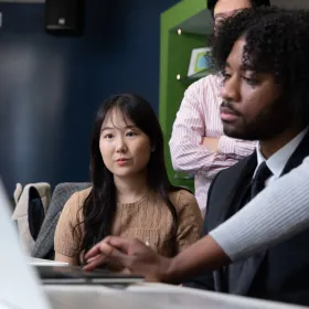 students looking at computer