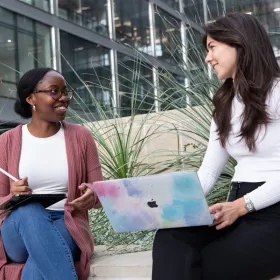 two students outside talking