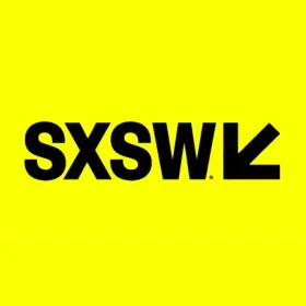 Black letters spell SXSW on a bright yellow background. Next to it a black arrow points to the bottom left corner of the screen.