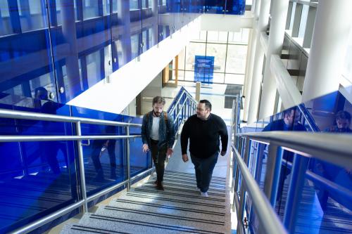 two students walk up stairs