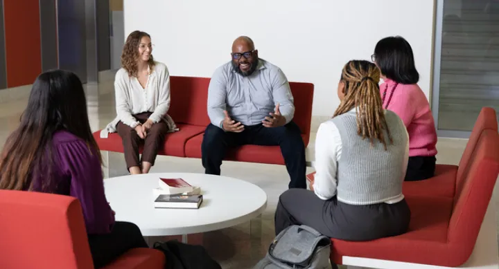 Faculty and students sitting and talking