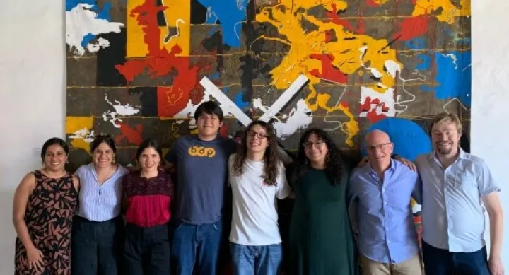 Seminar attendees in front of artwork