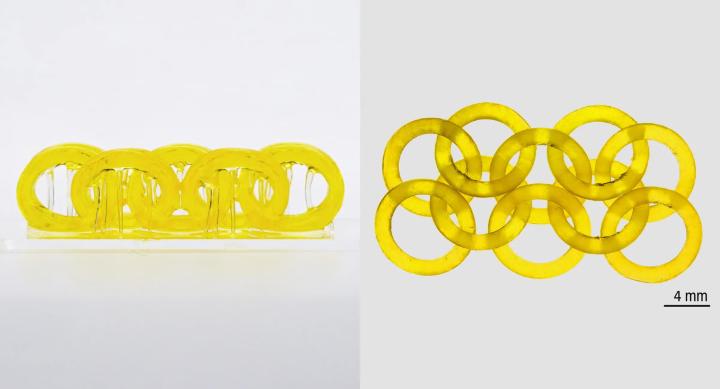 Two sets of golden interlocking rings. One of them is five rings linked in a chain shape, the other is 10 rings interlocked in a chain in sets of two.