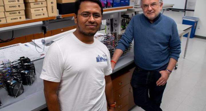 Two people stand in a laboratory.
