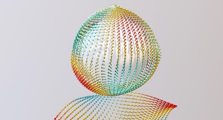 A computer-generated image of an antivortex polaron in a zinc-blende crystal, resembling a sphere rotating between two rectangles.
