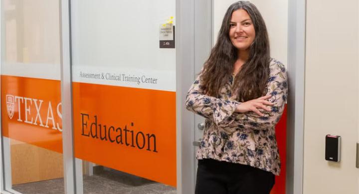 A person stands in front of an office labeled "Texas Education Assessment & Clinical Training Center."