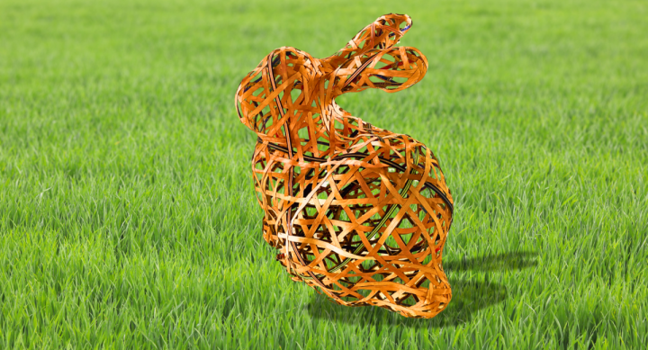 A woven bunny sculpture is depicted on some grass.